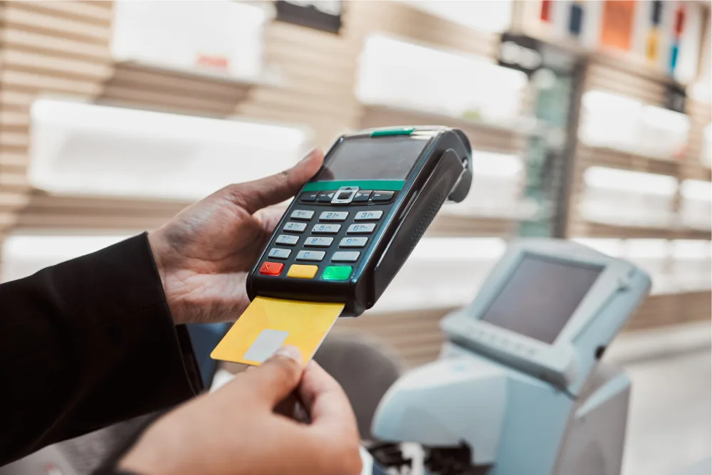 Eye care clinic staff accepting card payment from patient