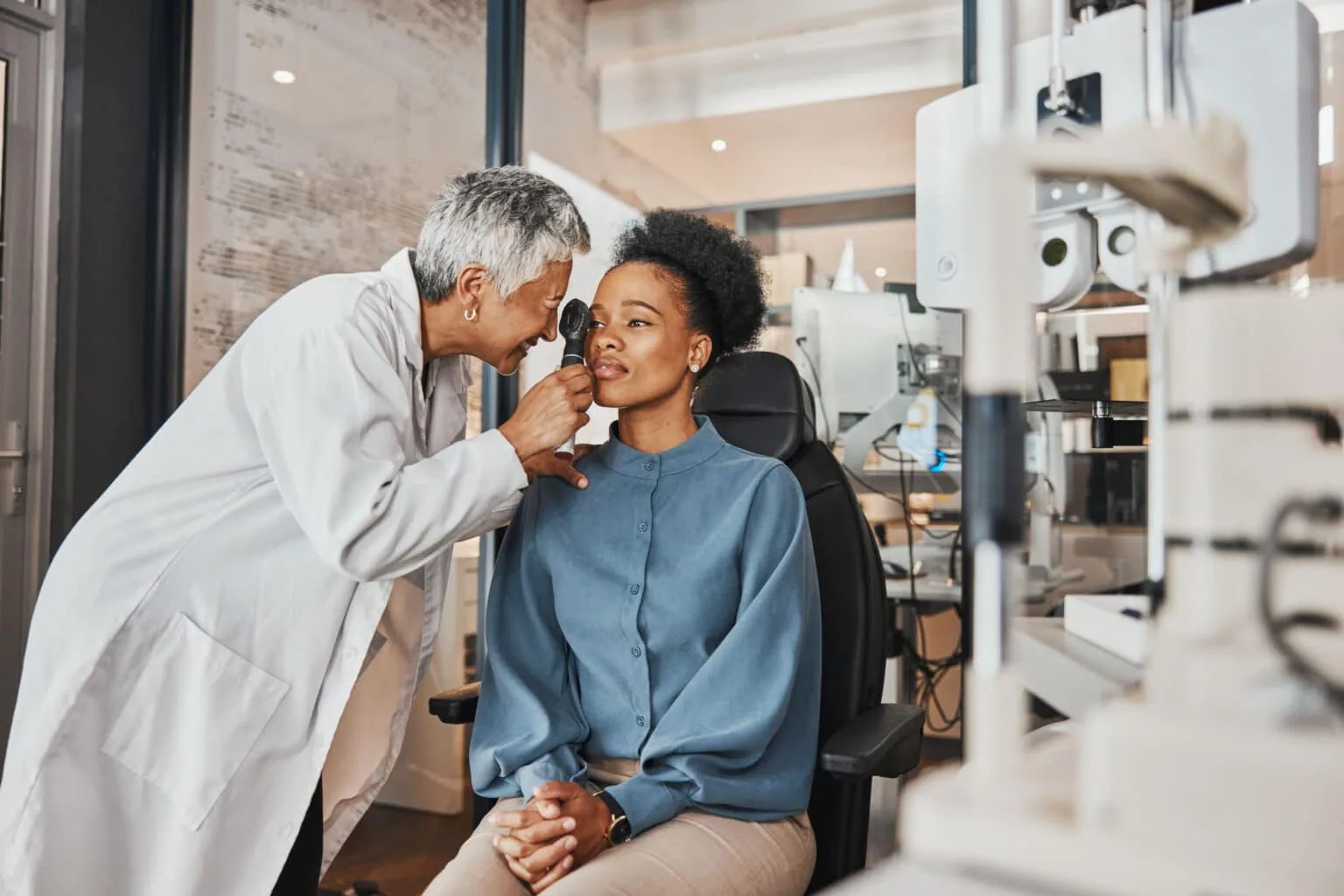Optometrist performing a comprehensive eye examination for a patient