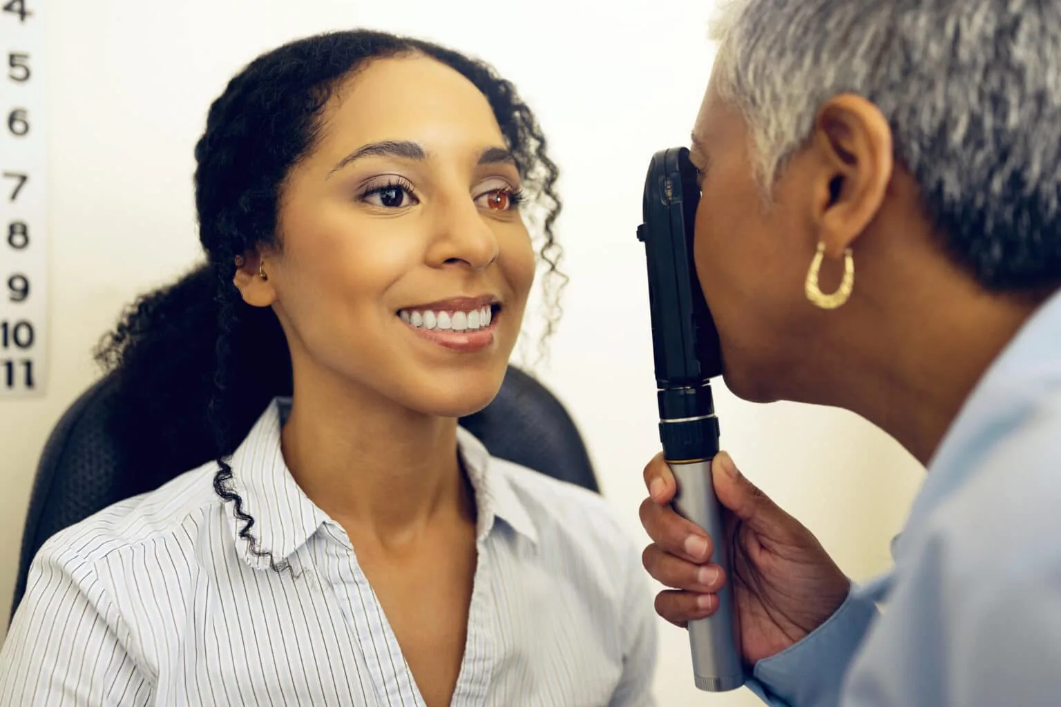 Optometrist examining a patient's eyes during a comprehensive eye exam